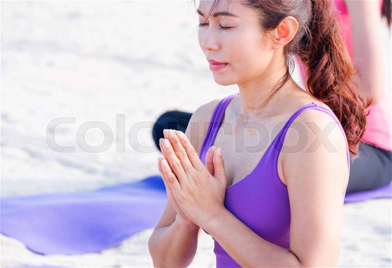 Close up female master yoga doing namaste pose with student at beach,Outdoor healthy activity sport, stock photo