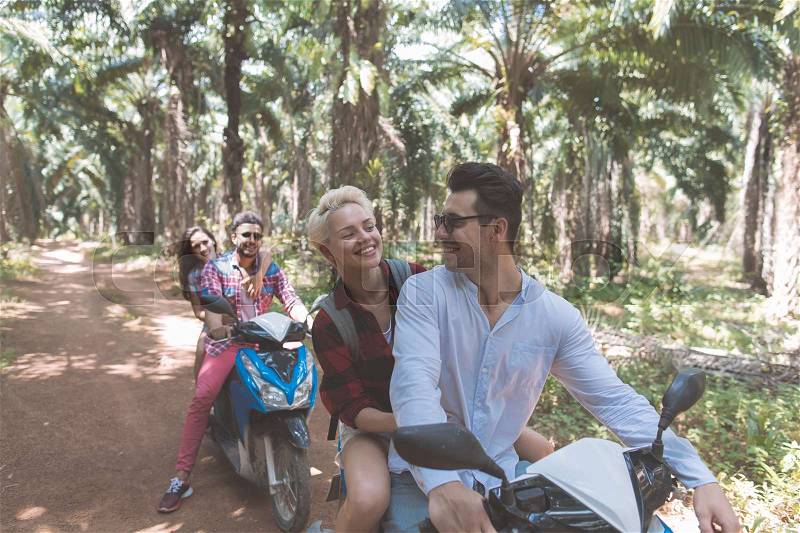 Happy People Ride Scooter Enjoy Summer Vacation While Road Trip Through Palm Trees Forest Two Couple Travel On Bikes Together Adventure And Freedom Concept, stock photo