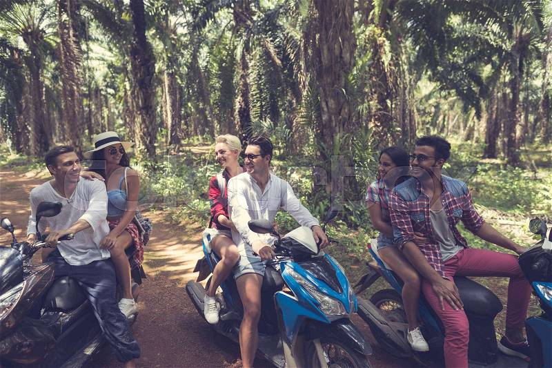 Young Group Of People Driving Scooters Travel In Tropical Forest Cheerful Friends Having Road Trip On Bikes Freedom And Youth Concept, stock photo