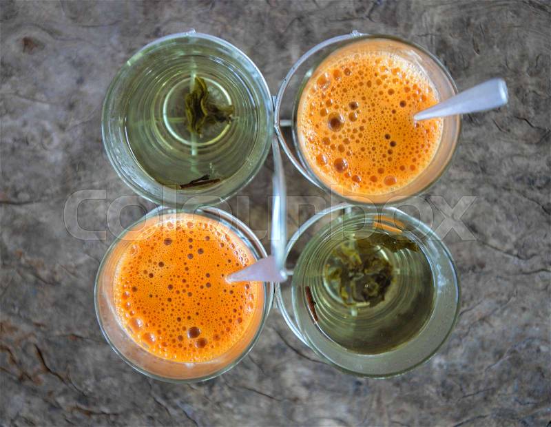 Orange hot Thai tea milk with water and pandanus, stock photo