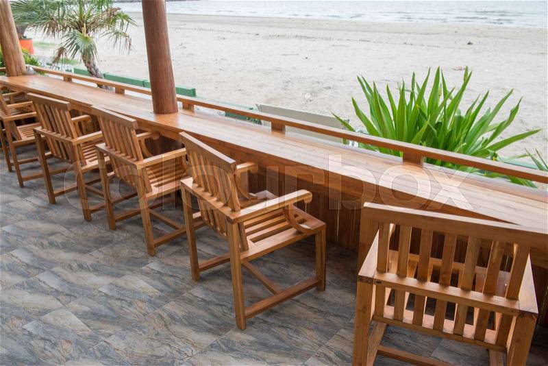 Table and wooden seats at the beach, stock photo