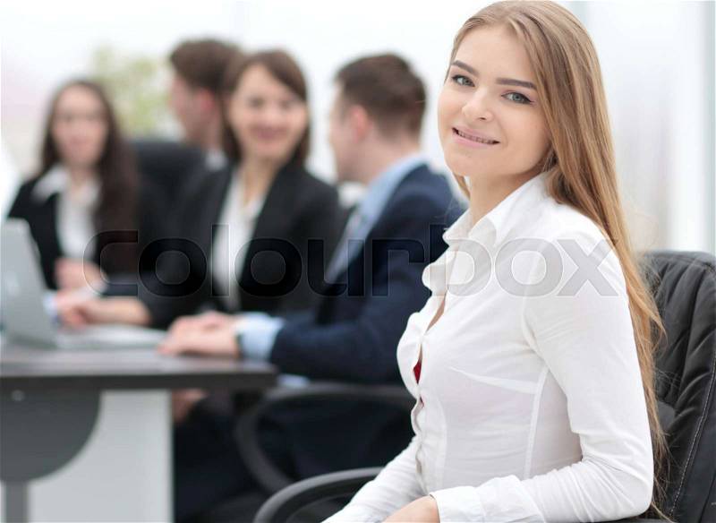 Young employee in the office on the background of colleagues, stock photo