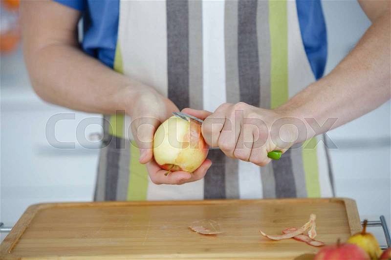 Man peeling an apple cut out, stock photo