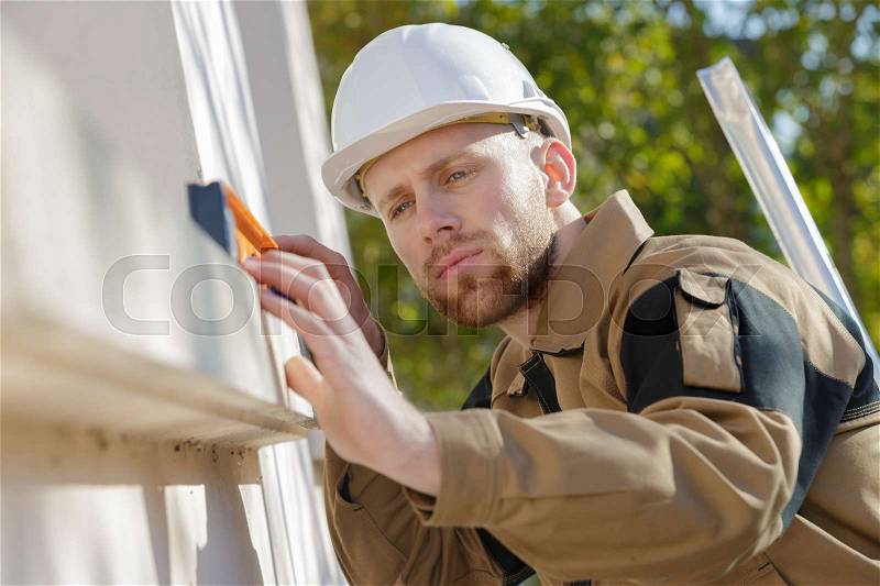 Inspecting the level of the beam, stock photo