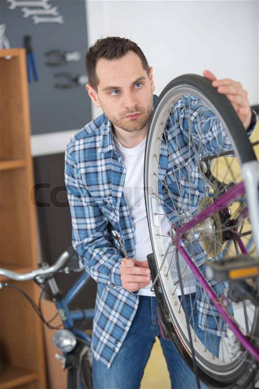 Technical expertise taking care bicycle shop, stock photo