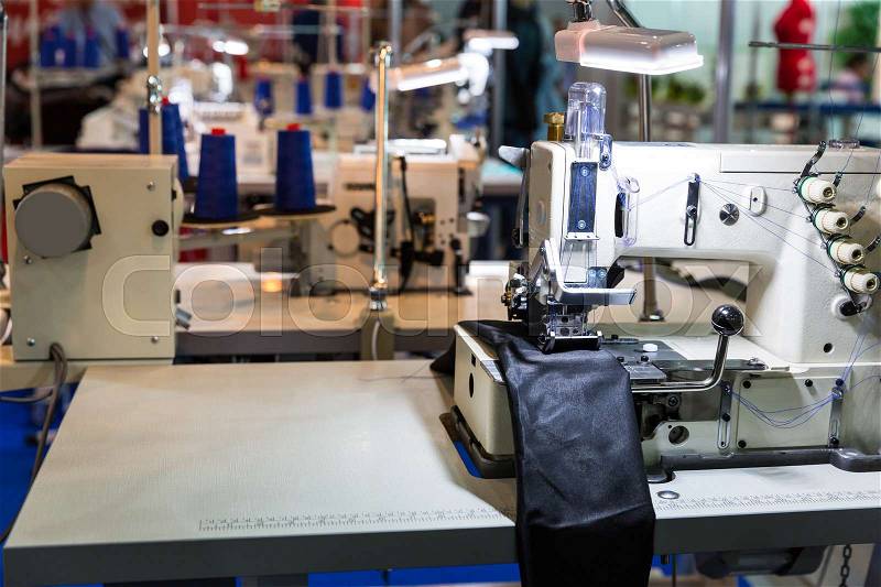 Sewing machine in cutting shop on leather cloth factory, nobody. Fabric production, sew manufacturing, needlework technology, stock photo