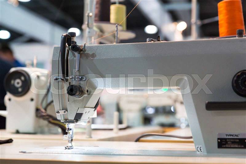 Overlock machine closeup, nobody, clothing sew. Textile fabric. Factory production, cloth manufacturing and needlework technology, stock photo
