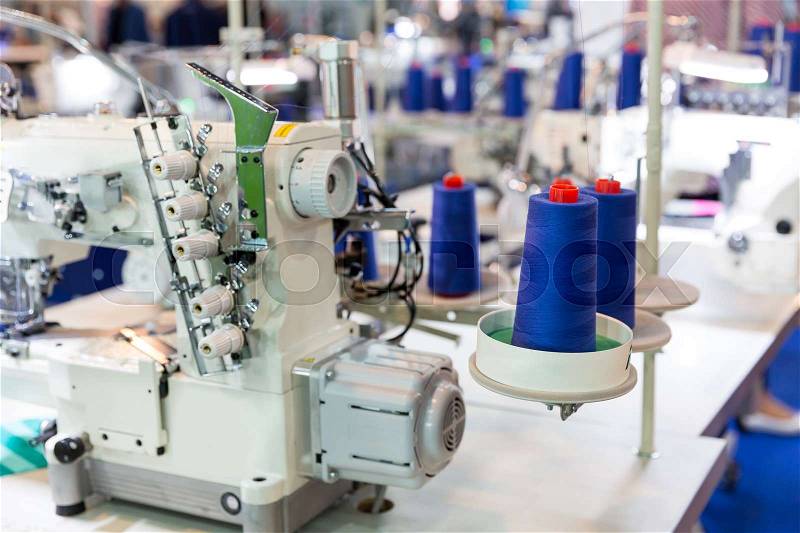Sewing machine and cloth, nobody, clothing factory. Fabric production, sew manufacturing, needlework technology, stock photo