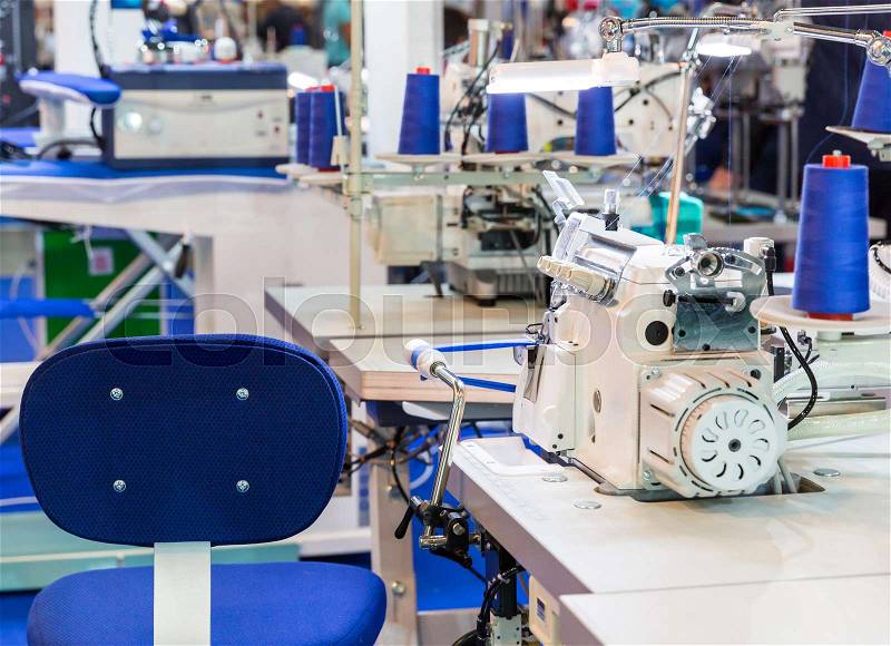 Sewing machine, nobody, clothing sew on fabric. Factory production, cloth manufacturing, dressmaker workplace, stock photo