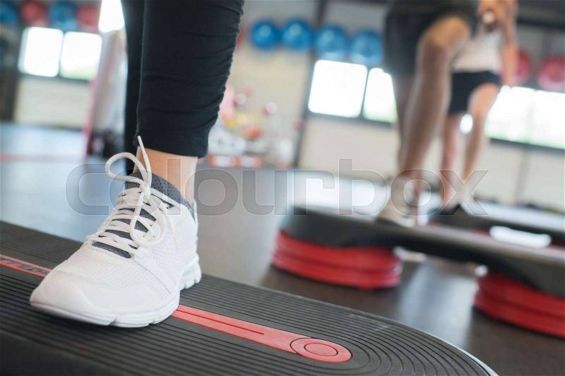 Close up of women foot exercising with stepper in gym, stock photo