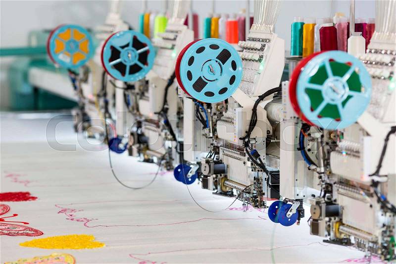 Factory sewing machine makes color pattern closeup. Textile fabric, nobody. Sew manufacturing, needlework technology, stock photo