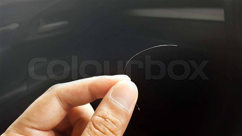 removal gray hair in hand, stock photo