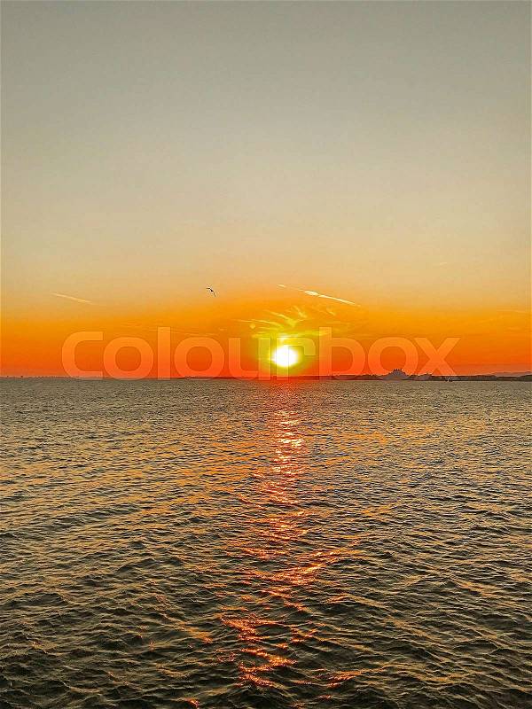 Sunset over water, stock photo