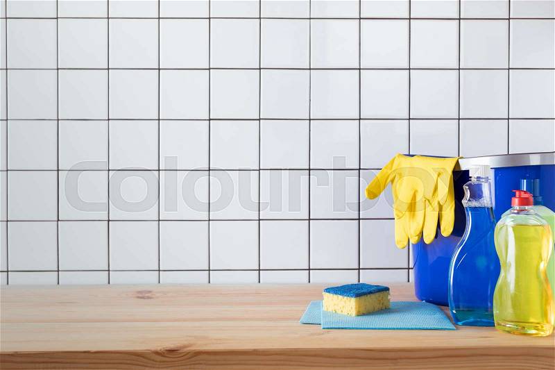 Various cleaning products, sponge, rags and bucket with protective gloves on tabletop , stock photo