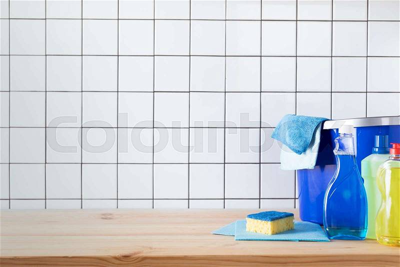 Various cleaning products, sponge, rags and bucket on tabletop , stock photo