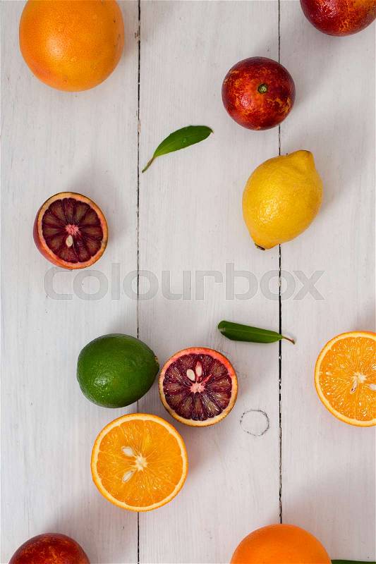 Citrus fruits on a white wooden background, stock photo