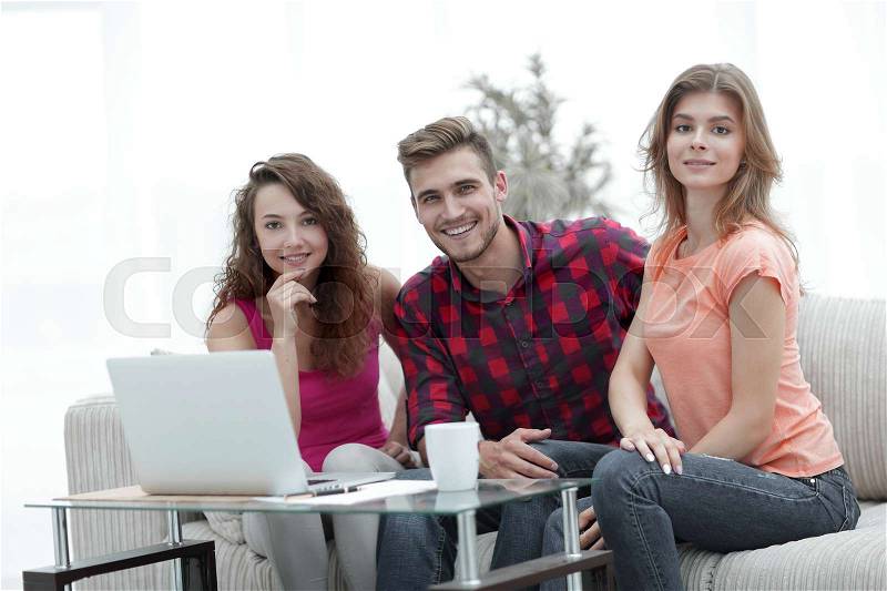 Group of students sitting on a couch behind a coffee table.photo with copy space, stock photo