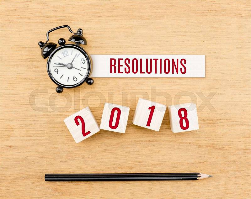 Resolutions 2018 new year red on wood cube with pencil and clock top view on wood table,New year business concept, stock photo