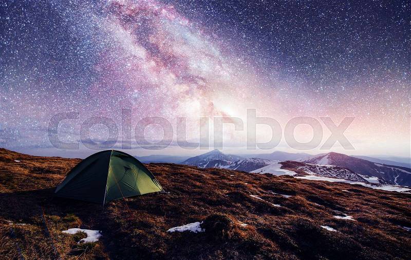 The starry sky above the tent in the mountains. Magic event in frosty day. In anticipation of the holiday. Dramatic scenes. Courtesy of NASA. Carpathians, Ukraine, Europe, stock photo
