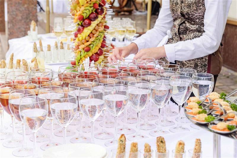 Outdoor Beautifully decorated catering banquet table with different food snacks and appetizers on corporate party event or wedding celebration. Service concept. Selective focus. Close up, stock photo