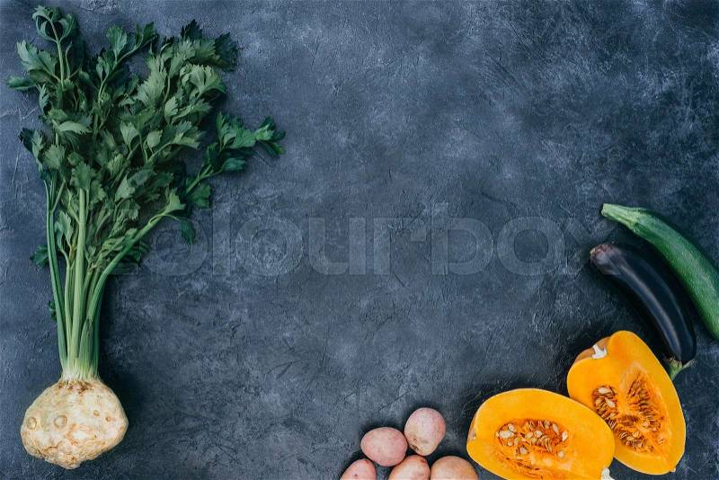 Top view of ripe seasonal vegetables on black slate board, stock photo