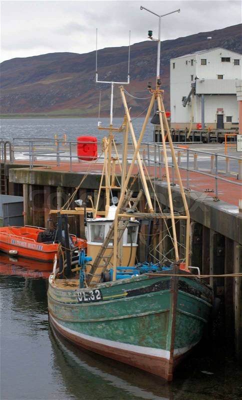 Small boat on a pier near Ullapool in Scotland, stock photo