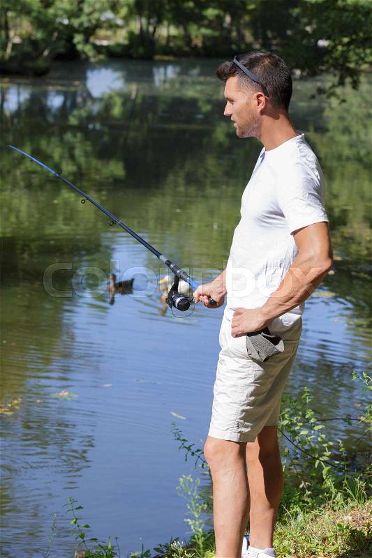 Fishing man with fishing rod river outdoor, stock photo