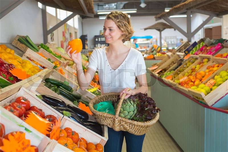 Young woman customer in fruit store, stock photo