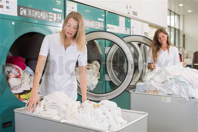 Laundry employees at work, stock photo