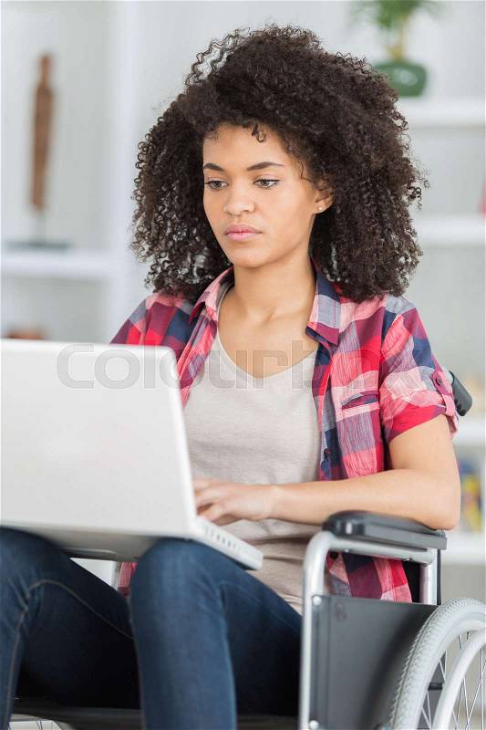 Job for disabled people woman on wheelchair with laptop, stock photo