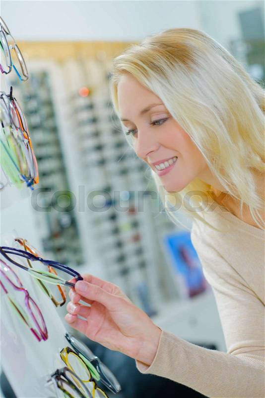 Girl buying glasses, stock photo
