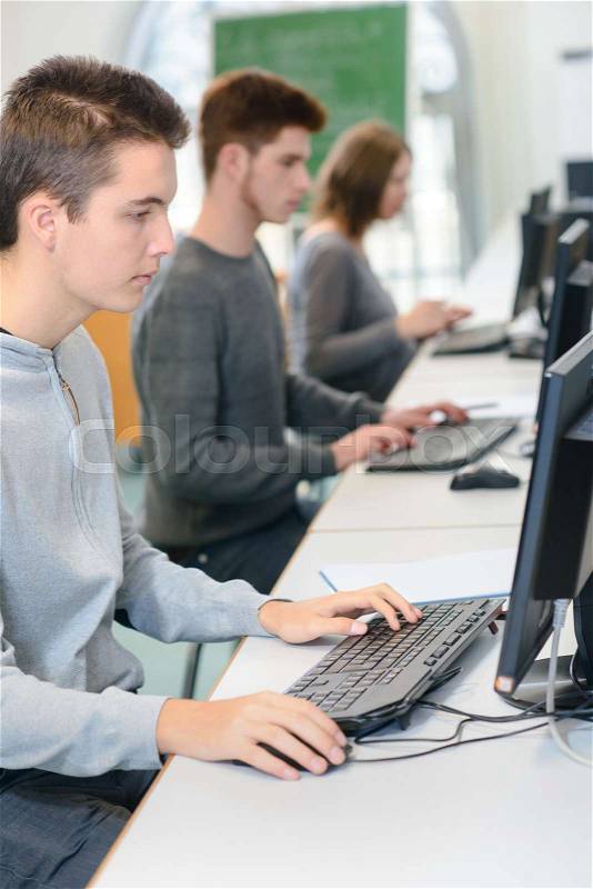 Group of college students attending a computer class, stock photo