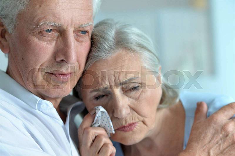 Portrait of sad senior couple looking away, stock photo