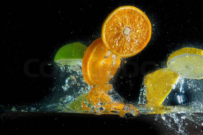 Fruit splashing in the water, stock photo