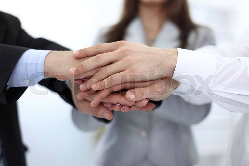 Concept of reliability: hands of business teams stacked together, stock photo