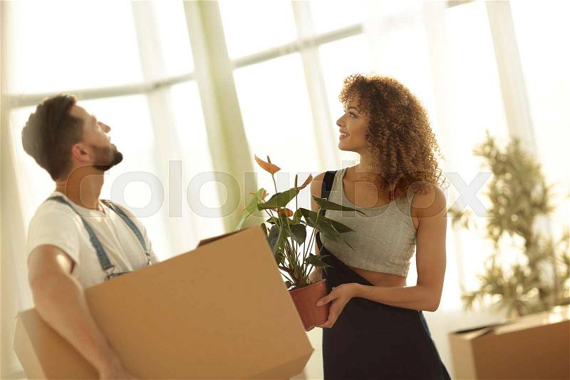 Family brings boxes with things to a new apartment. Photo has a copy of the space, stock photo