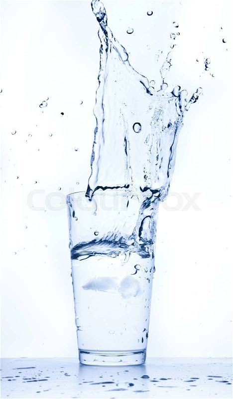 Water splashing from glass isolated on white background, stock photo