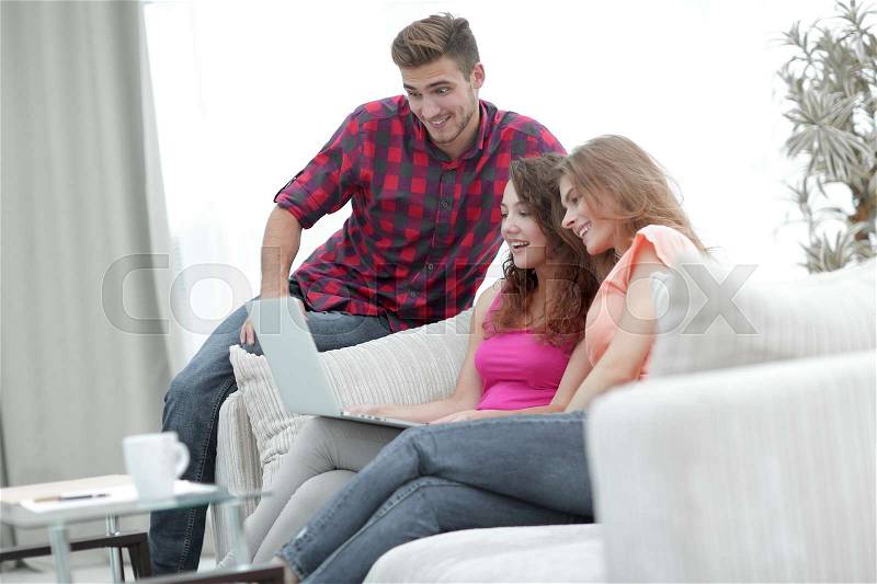 Portrait of a group of young people watching videos on the laptop, stock photo