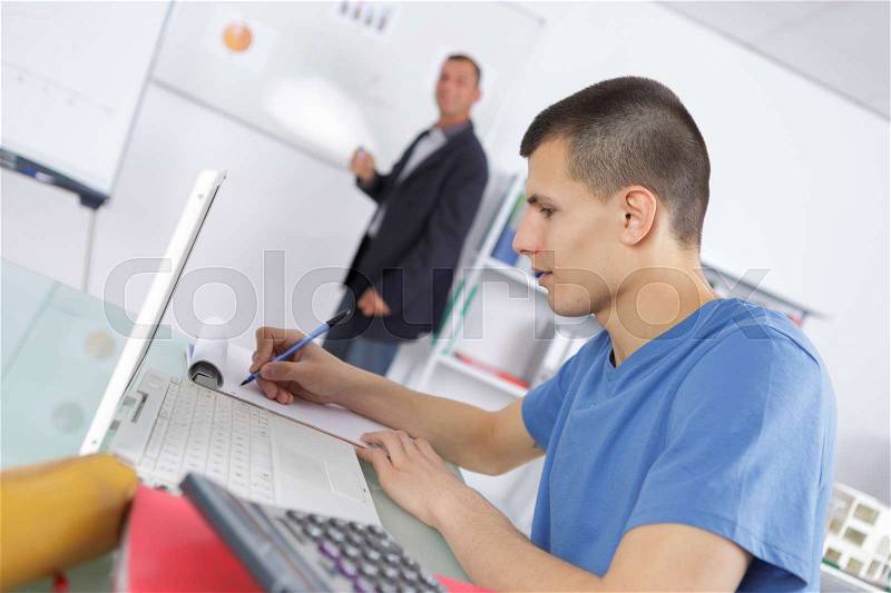 Academic teacher and students in a class, stock photo