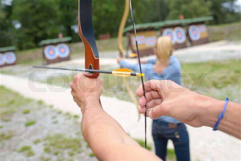 People at an archery competition, stock photo