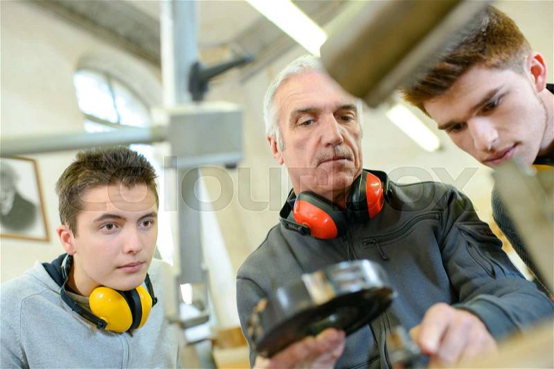 Group of students in woodwork training course, stock photo