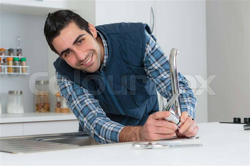 Happy plumber, stock photo