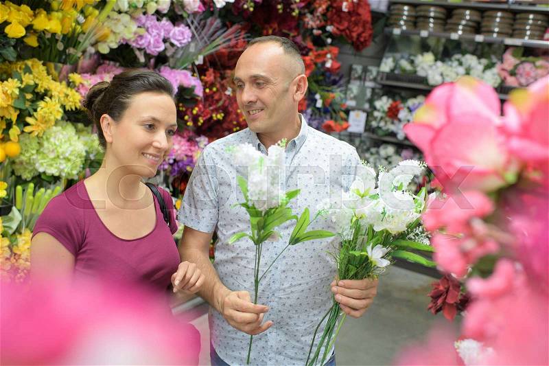 Man sells flowers in the flower shop, stock photo