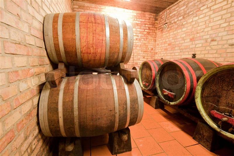 Wine barrels in old wine cave, stock photo