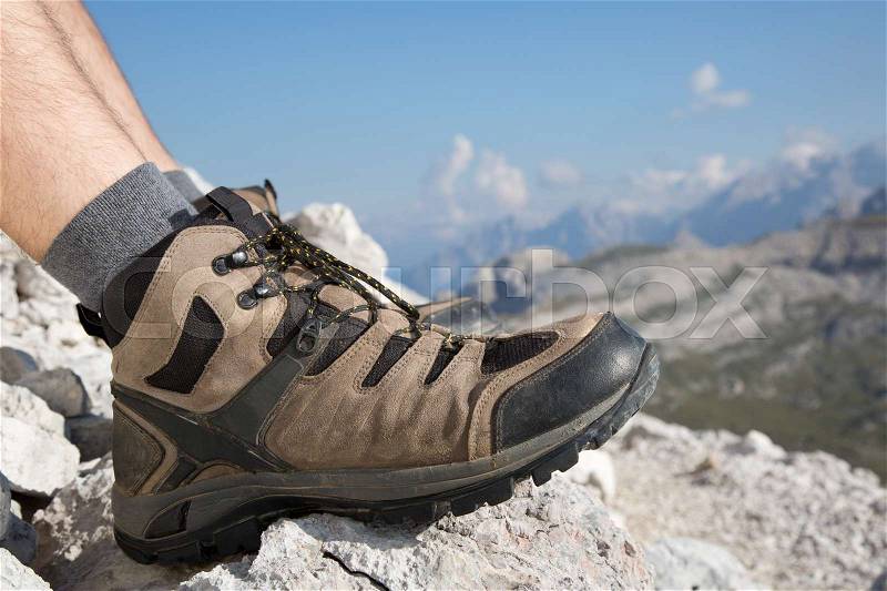 Hiking boots of a hiker while taking a rest in the mountains, stock photo