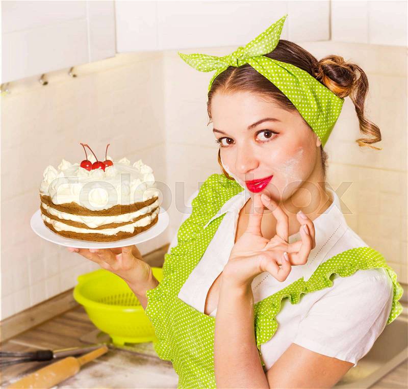 Young woman in retro clothes cooking sweet desert in the kitchen, stock photo