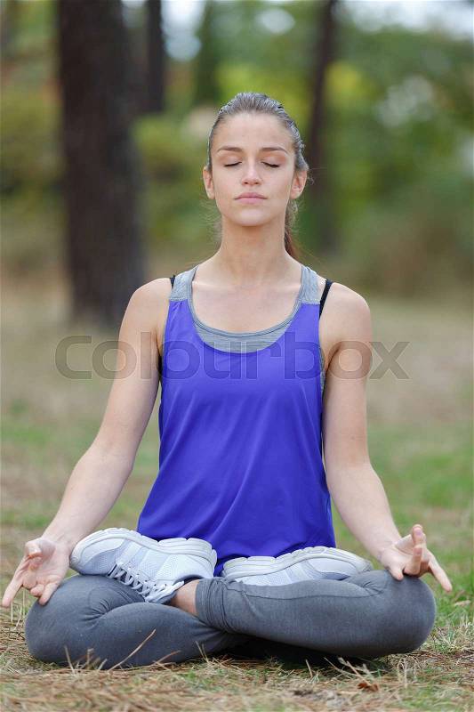 Woman on a yoga mat to relax outdoor, stock photo