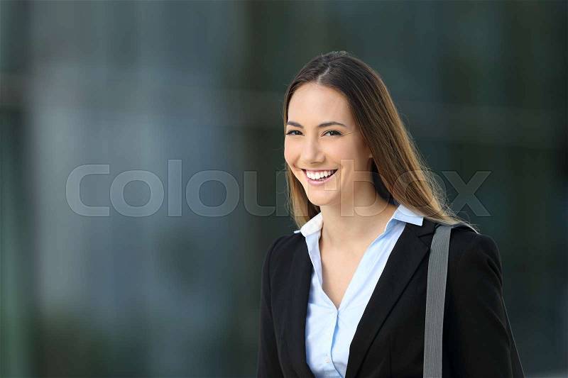 Single confident executive looking at you standing on the street, stock photo