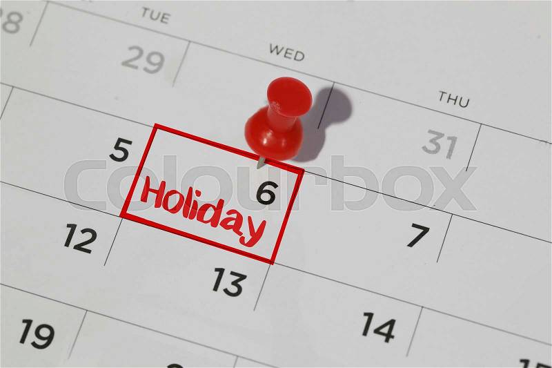 Red highlighter with holiday date on calendar, stock photo