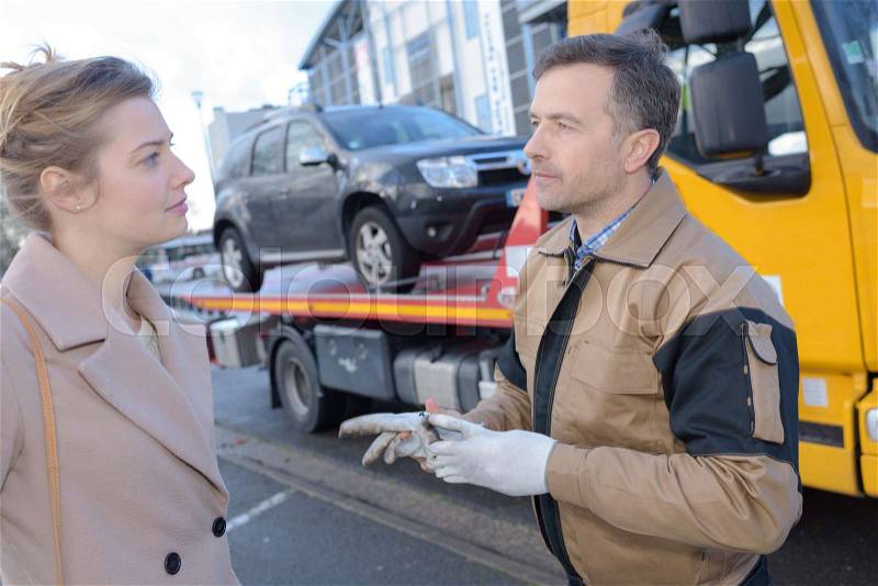 Woman talking to broken car assistance, stock photo